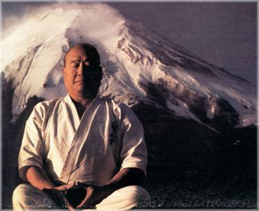 Sosai Masutatsu Oyama, The Founder of Kyokushin Karate sitting in front of a mountain